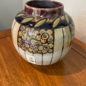 Photo of Pottery vase with floral motif.