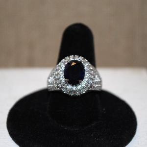 Photo of Size 8 Dark Blue Irridescent Oval Stone Ring with Side Accents on a Silver Tone 