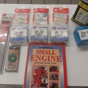Photo of Small engine repair book with brand new car parts - U joints - Piston Ring Compr