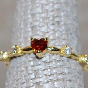 Photo of Size 8 Single Red Heart Shaped Stone Ring with Side Accents on a Gold Tone Band 