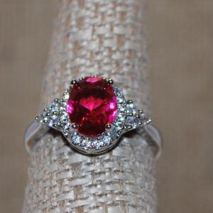 Photo of Size 7 Red/Pink Cushion Cut Stone Ring with Pointed Side Accents on a Silver Ton