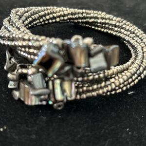 Photo of Silver tone beaded with black designs wire bracelet