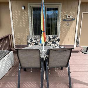 Photo of PATIO TABLE WITH UMBRELLA AND 4 PATIO CHAIRS WITH CUSHIONS