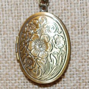 Photo of Oval Flowered Brass Style Locket PENDANT (1¼" x 1") on a Dark Gold Tone necklac