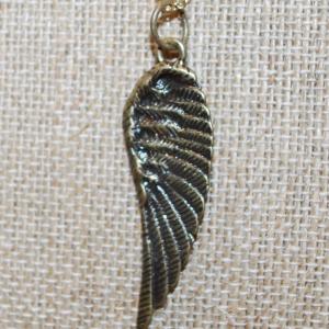 Photo of Brass Tone Bird Wing PENDANT (2" x ½") on a Gold Tone Adjustable Necklace Chain