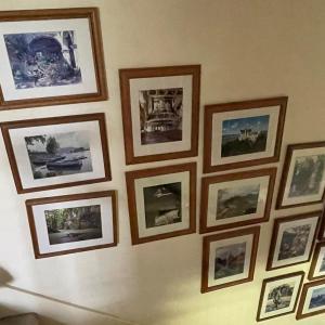 Photo of Lot of Framed Photographs on wall