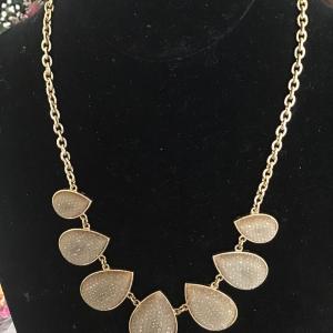 Photo of necklace blonde gold tone chain bib Light gray teardrop design Necklace