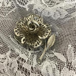 Photo of Rose-shaped silver tone filigree brooch marked Lisener