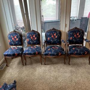 Photo of 4 VINTAGE CHAIRS IN CARVED WOOD AND CASTERS ON THE FRONT LEGS