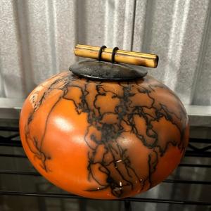 Photo of Orange And black Pot With Lid