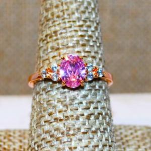Photo of Size 8 Pink Oval Faceted Stone Ring with 3 Clear Stones Side Accents on a Rose G