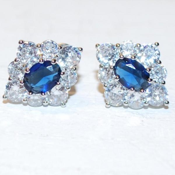 Photo of Oval Blue Center Stone Earrings Set with a Diamond-Style Shaped Cluster Surround