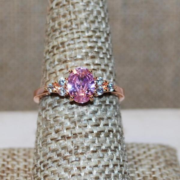Photo of Size 7 Pink Oval Faceted Stone Ring with 3 Clear Stones Side Accents on a Rose G