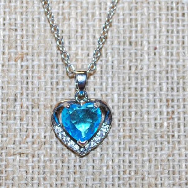 Photo of Pretty Heart Shaped Blue Faceted Stone Inside a 10 Clear Stone Silver Heart PEND