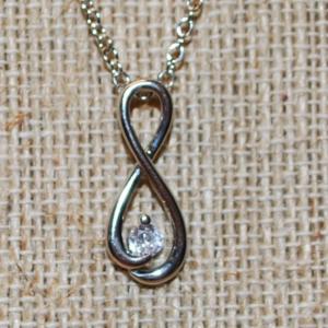 Photo of Figure "8" Symbol PENDANT (1" x ½") with a Single Clear Stone Accent on a Silve