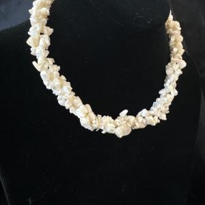 Photo of Vintage ivory chipped, puka shell three strand twist necklace