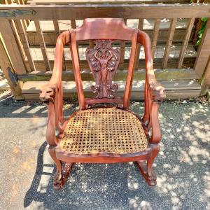 Photo of LOT 143 S: Vintage Ornate Wooden Rocker w/ Cane Seat, Lion Head Arm Rests, Claw 