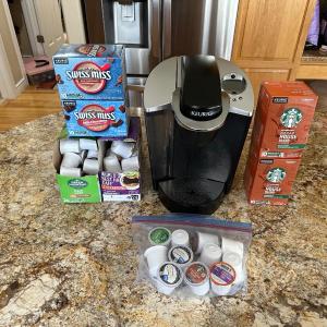 Photo of KEURIG COFFEE MAKER W/VARIETY OF POD COFFEE AND HOT CHOCOLATE