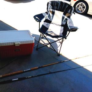 Photo of OZARK TRAIL FOLDING CHAIR, 2 FISHING POLES AND A COOLER