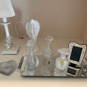 Photo of Perfume bottles with lamp, frames and tray