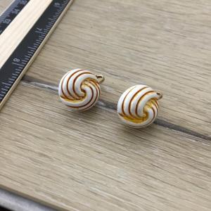 Photo of White vintage Hong Kong marked gold tone clip on earrings