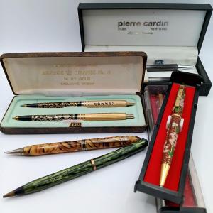 Photo of LOT 309: Arpege Chanel No. 5 14kt Gold Pens, Kofa Cloisonne Enamel Pens, Pierre 